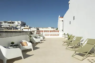 a patio with chairs and tables on a building at Casa São Francisco Old Town Faro in Faro