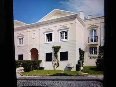 a bedroom with two beds and a window at Nice flat in pretty condo in Quarteira
