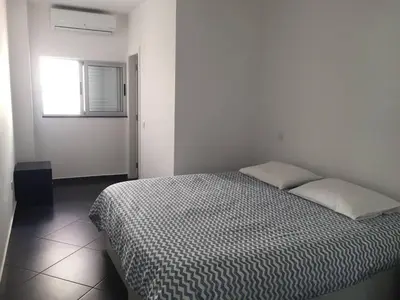a bed in a white room with a window at Casa com 3 suites, jacuzzi , en Albufeira in Albufeira
