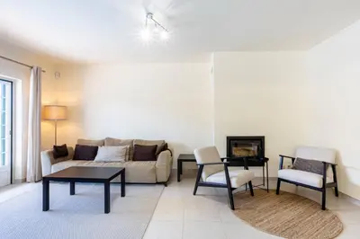 a living room with a couch and a table at Villa Moura by HelloVacations in Loulé