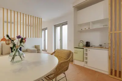 a kitchen and living room with a table and chairs at SUNSET VILLA - Luxury villa with superb pool and great views in Faro