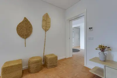 a living room with two stools and a plant on the wall at SUNSET VILLA - Luxury villa with superb pool and great views in Faro