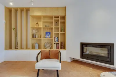 a living room with a chair and a fireplace at SUNSET VILLA - Luxury villa with superb pool and great views in Faro