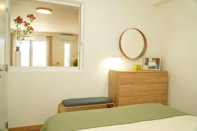 a bedroom with a bed and a mirror and a dresser at Pilar Apartment in Albufeira