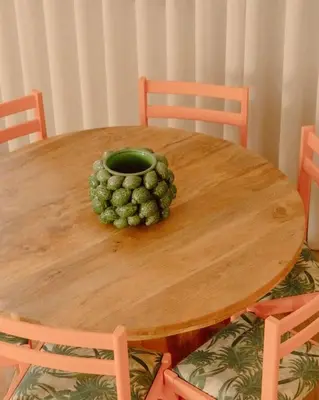 a wooden table with a bowl of grapes on it at Glam House no coração da cidade in Faro