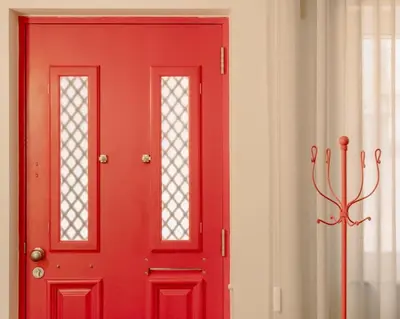 a red door with two windows in a room at Glam House no coração da cidade in Faro