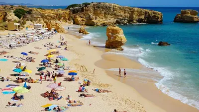 a bedroom with a bed and a lamp on a table at Apartment - Sleeps 2 Parking & Pool Access in Albufeira