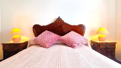 a bedroom with a bed with two nightstands and two lamps at Apart Alfarrobinha - T2 - BY BEDZY in Tunes