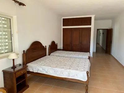 a large kitchen with wooden cabinets and a sink at BnB Homes Luxurious Villa Stardust with Swimming pool & BBQ for Family Fun in Ameijoafas