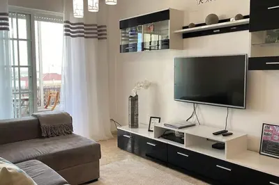 a living room with a large flat screen tv at The Luna Apartment Faro - 2 Bedroom Private Apartment in Faro