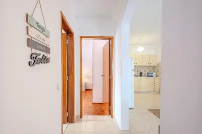 a hallway with a door leading to a kitchen at Apartamento Briza by Sunnyway in Albufeira