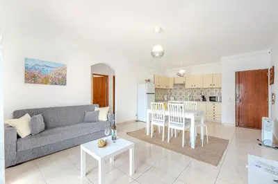 a living room with a couch and a table at Apartamento Briza by Sunnyway in Albufeira