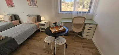 a small room with a desk and a bed and a table at Ideal Bubble House in Faro