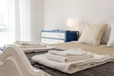 a bedroom with white towels on a bed at Color me Happy - 2 bedrooms apartment near Forum Algarve in Faro