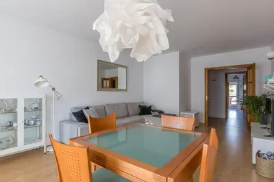 a living room with a table and a couch at Home away from Home in Faro