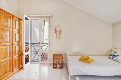 a white room with a bed and a closet at T2 duplex na Marina de Vilamoura in Loulé