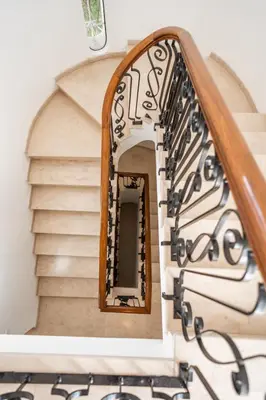 a spiral staircase with a mirror on the wall at Luxurious Villa - Pool, Hot Tub, Cinema and Golf in Vilamoura