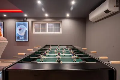 a room with a large pool table in it at Luxurious Villa - Pool, Hot Tub, Cinema and Golf in Vilamoura