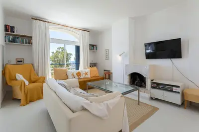 a living room with a couch and a fireplace at TAC - Windmill OceanFront Villa in Albufeira