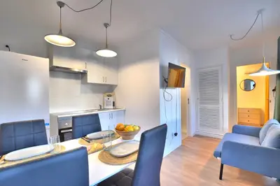 a kitchen and a living room with a table and chairs at Old Town Gem by Atlantic Places in Albufeira