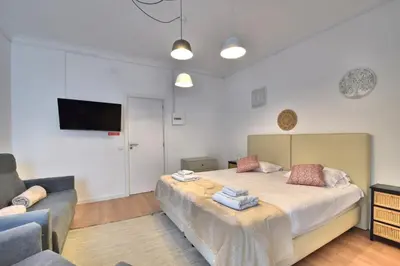 a bedroom with a large bed and a couch at Old Town Gem by Atlantic Places in Albufeira