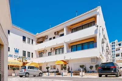 two cars parked in front of a building at Apartment Monaco mit Pool in Albufeira