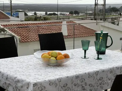 a bowl of fruit on a table with a view at Casa MarRia in Faro