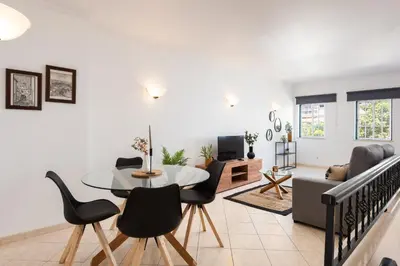 a living room with a table and chairs at Oasis apartment - City center by HD in Faro