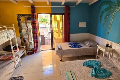 a bedroom with two beds and a room with a window at Villa Ania - Private Villa with pool&Jacuzzi, 16 to 40 pax in Albufeira