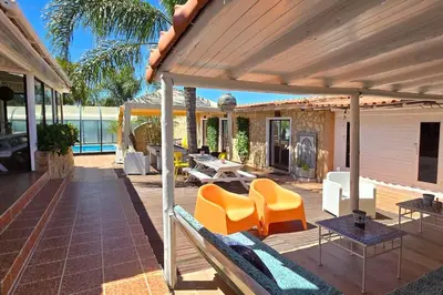 an outdoor patio with orange chairs and tables at Villa Ania - Private Villa with pool&Jacuzzi, 16 to 40 pax in Albufeira