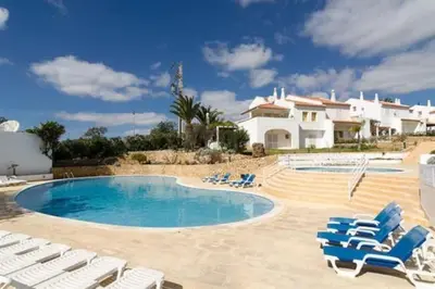 a swimming pool with lounge chairs and a house at Da Vinci Villa Salgados-Guia-Algarve in Albufeira