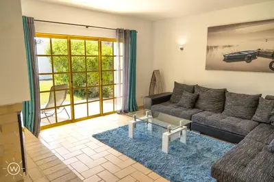 a living room with a couch and a table at Sunshine Villa Salgados Guia Algarve in Albufeira