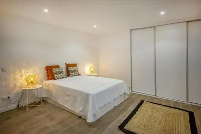 a bedroom with a large bed and two lamps at Krystal Bay Villa in Albufeira