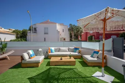 a patio with couches and a table on a roof at Krystal Bay Villa in Albufeira