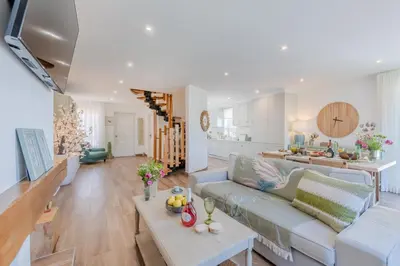 a living room with a couch and a table at 5 star Luxury SevenPines apartment with large balcony and 3 communal pool in Quarteira