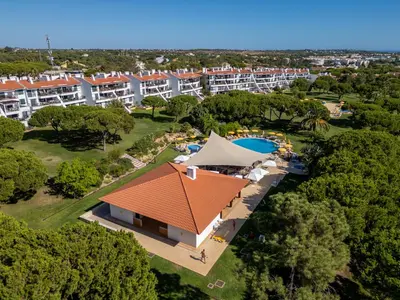 an aerial view of a resort with a swimming pool at 5 star Luxury SevenPines apartment with large balcony and 3 communal pool in Quarteira
