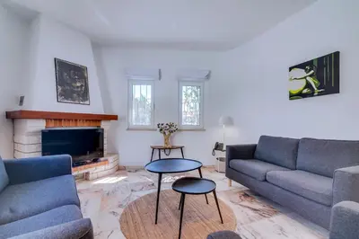 a living room with two couches and a fireplace at Villa Andorra, private pool next to golf in Vilamoura