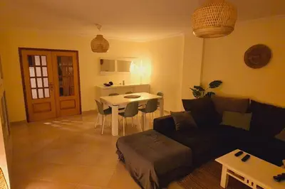 a living room with a couch and a table at T3 - Casa Jerome in Quarteira