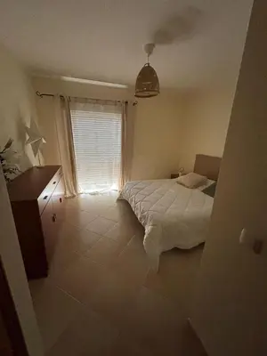 a bedroom with a bed and a window at T3 - Casa Jerome in Quarteira
