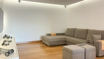 a living room with a couch and a table at Refúgio Sereno Vilamoura T2 by HsR Vilamarina in Quarteira