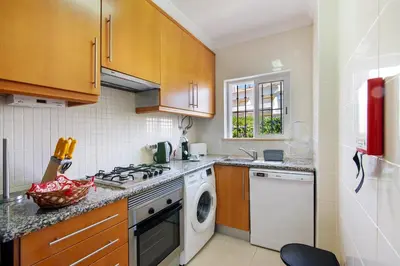 a kitchen with a stove top oven next to a dishwasher at Encosta São José in Guia