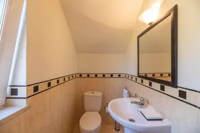 a bathroom with a sink and a toilet and a mirror at Villa Água in Albufeira