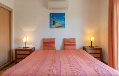 a bedroom with a white bed and a window at Villa Costa in Albufeira