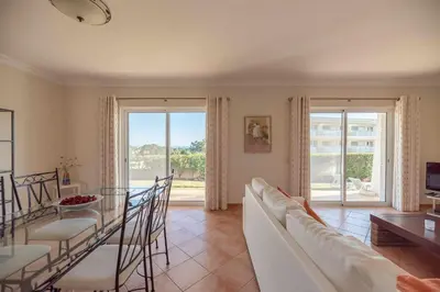a living room with a white couch and a table at Villa Costa in Albufeira