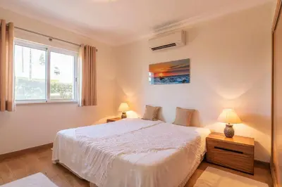 a living room with a white couch with orange pillows at Villa Costa in Albufeira