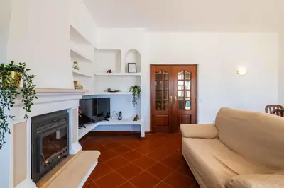 a living room with a couch and a fireplace at Villa Eulália in Guia