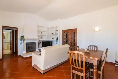 a kitchen with wooden cabinets and a tile floor at Villa Eulália in Guia