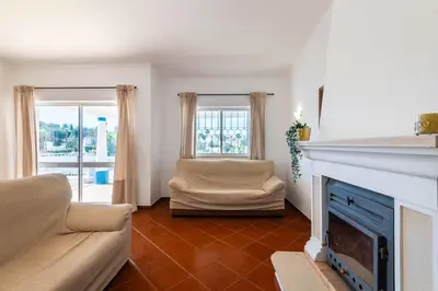 a living room with a fireplace and a couch at Villa Eulália in Guia