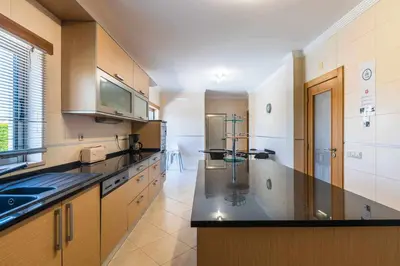 a kitchen with a sink and a counter top at Villa Hunês in Guia