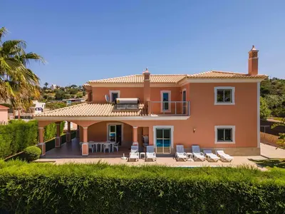 a large house with chairs and a balcony at Villa Hunês in Guia
